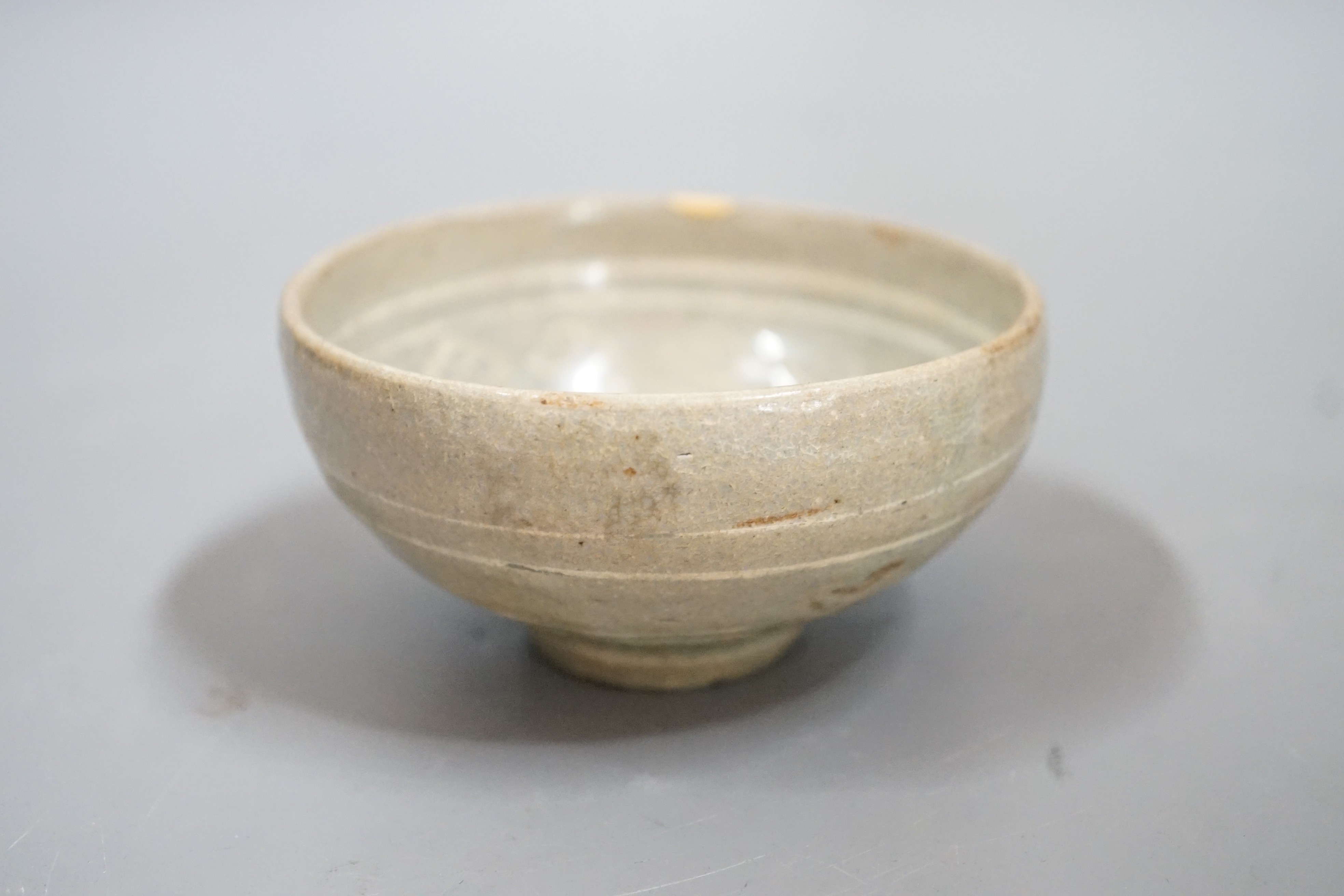 A Korean slip decorated celadon small bowl, Koryo dynasty. 10cm diameter